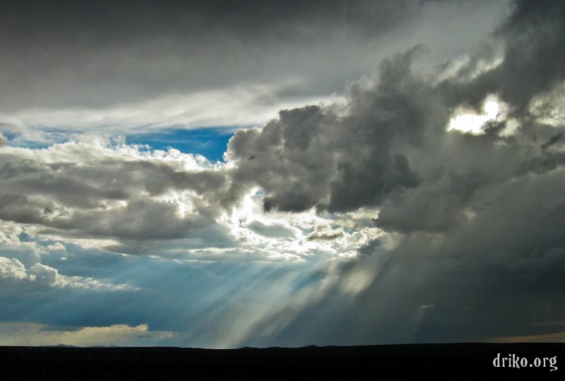 IMG_1965_800.jpg - The sun tries to peer through some storm clouds moving through the Mojave Desert.  We barely outran the worst of this storm on the road from Las Vegas to China Lake, CA...